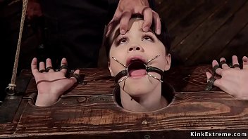 With spider gag in mouth raven haired spinner Yhivi with head and wrists in wooden stock gets hard whipped then master Ramon Nomar bangs her hairy cunt