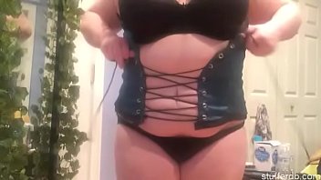 Fatass whore squeezes into a corset
