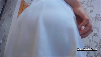 Perfect girl in a sexy white dress teasing upskirt for camera