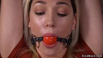 Gagged blonde sub shackled against wooden wall gets tits rubbed by master
