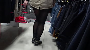 Peeping and hidden cam in community store and fitting room. Voyeur hunts for big booty under a short skirt and slender legs in pantyhose.