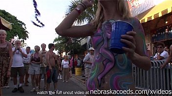 body painted and flashing girls during the day at mardi gras like festival